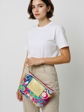 Coach Poppy wristlet is made of signature canvas